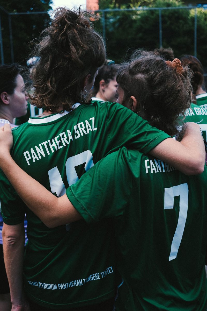 Players wearing matching green team jerseys
