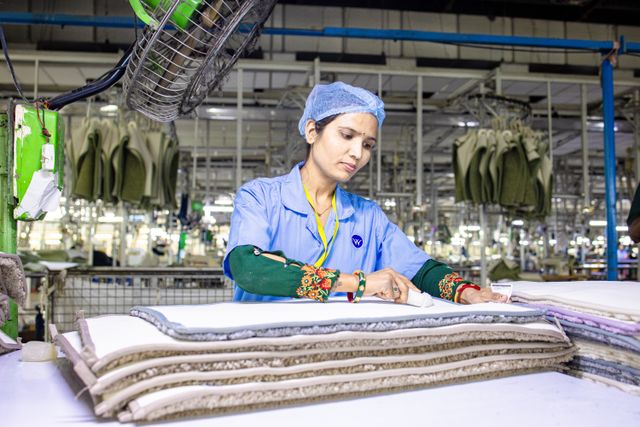 Apparel worker preparing fabric in a production environment