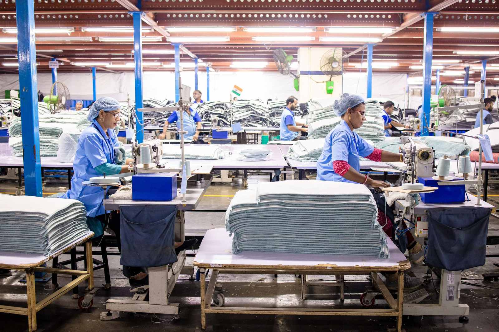 Organised garment workshop with prepared fabric stacks