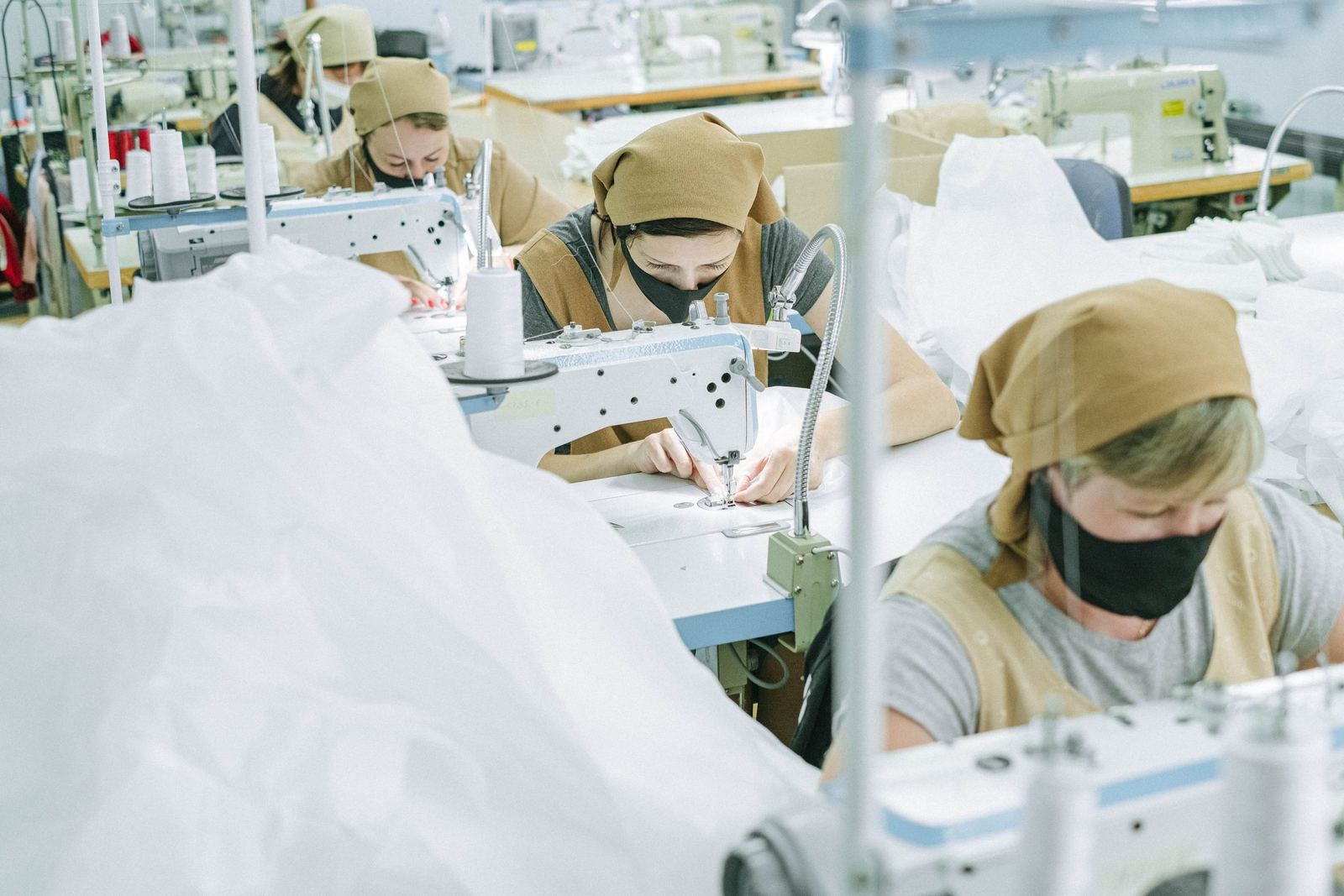Garment workers sewing apparel in a bright workshop