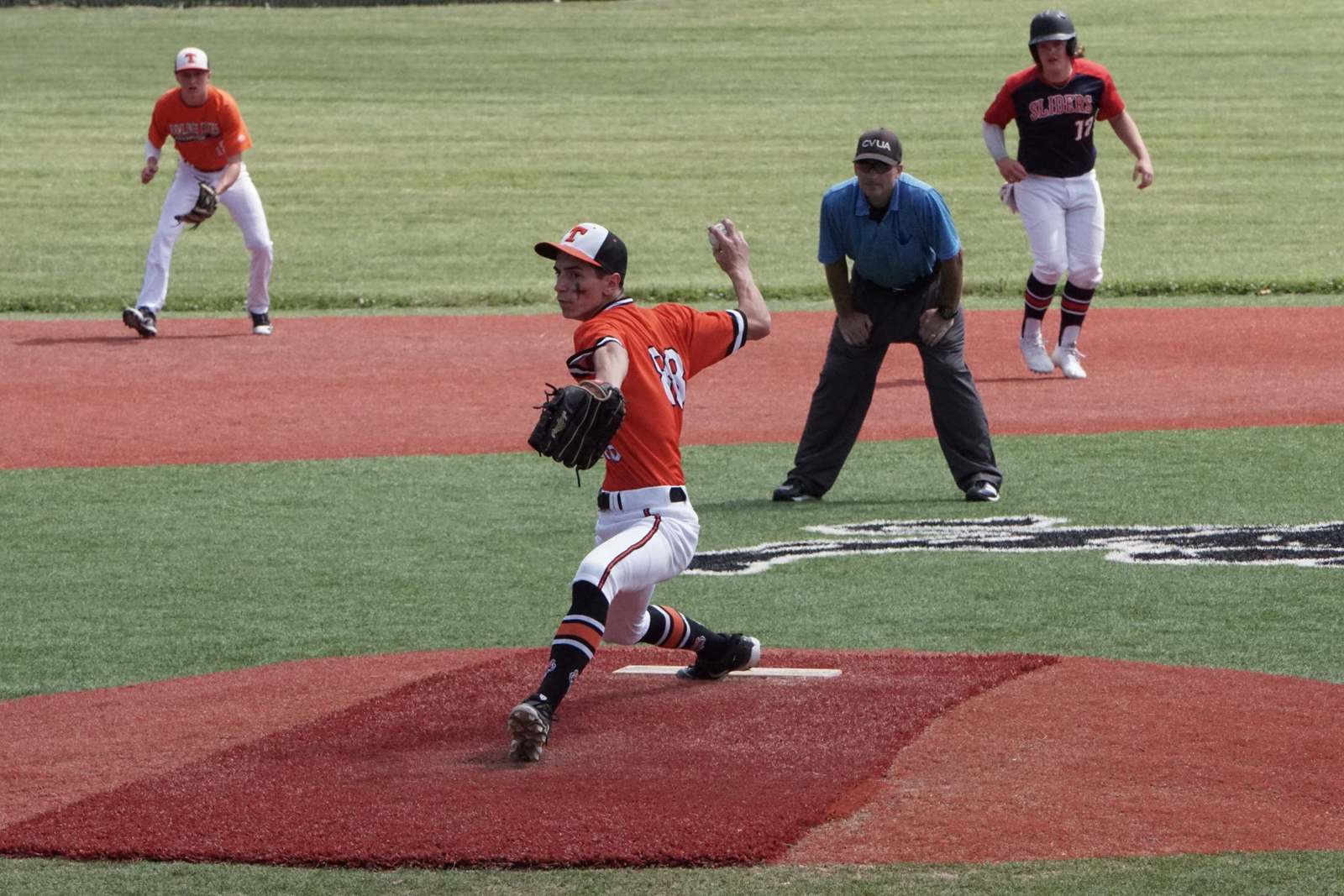 Baseball team member wearing a red jersey during a game