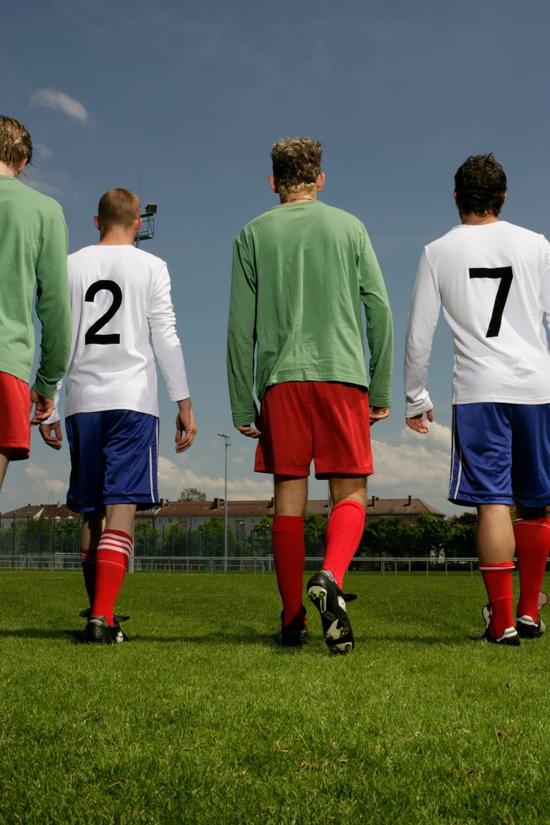 Young football players wearing numbered training jerseys