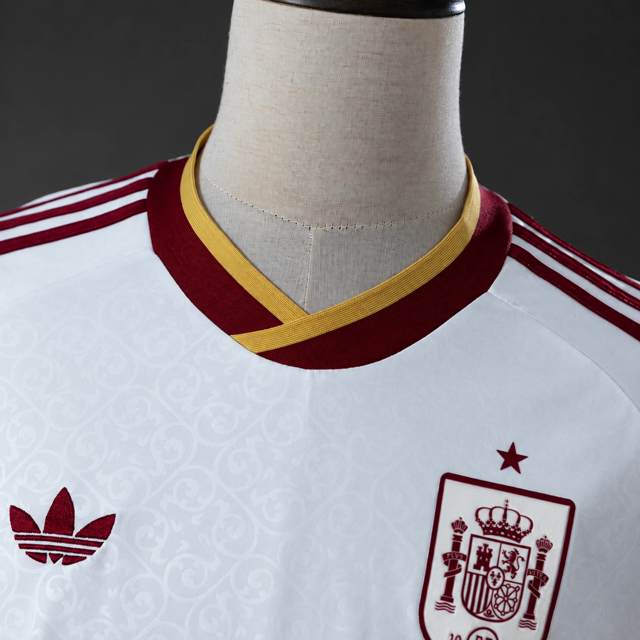 Close-up of a burgundy and gold football jersey collar and neckline stitching